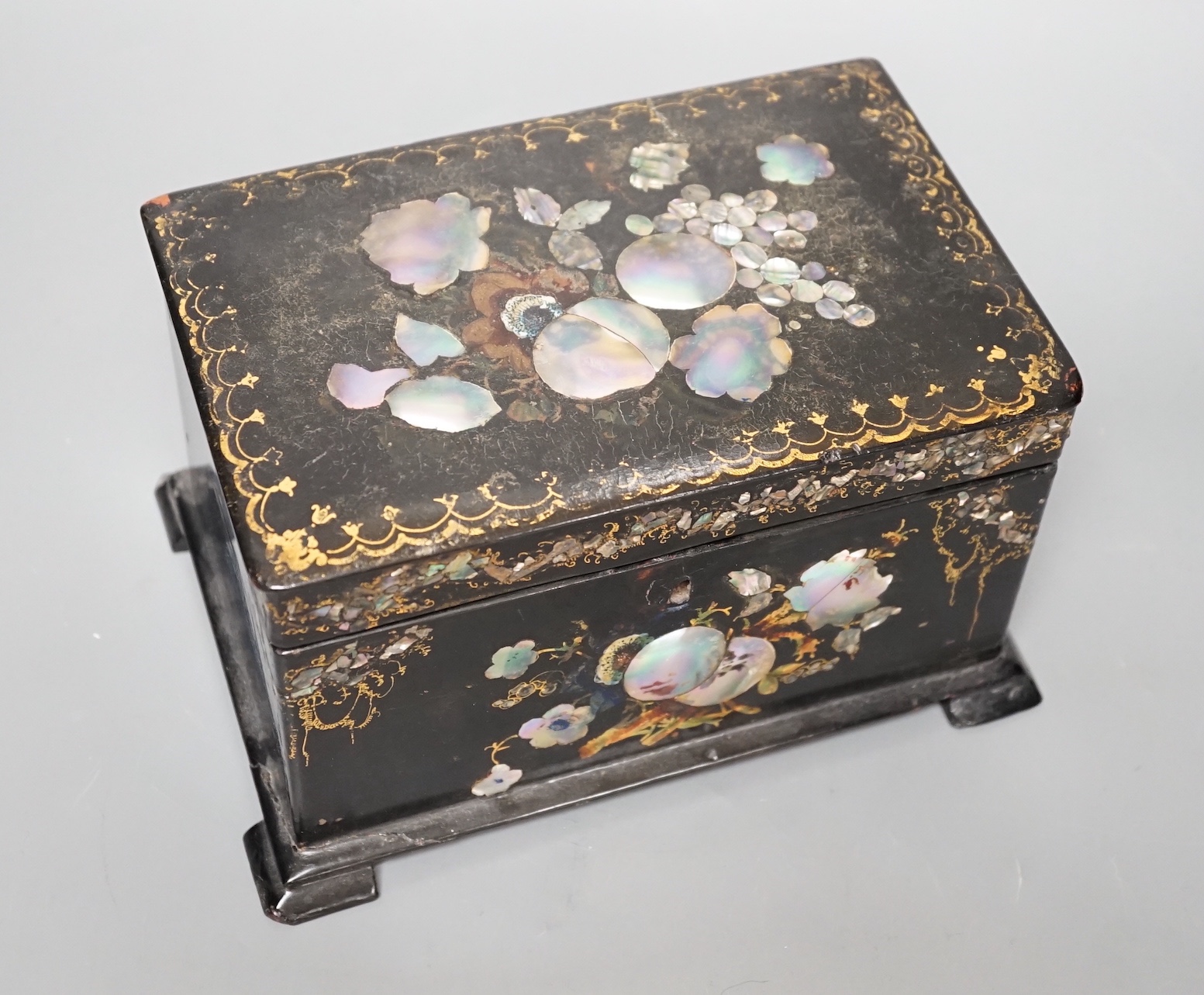 A Victorian inlaid papier mache tea caddy, 21cm wide